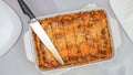 Fresh baked beef lasagna in baking dish close up on marble kitchen table Royalty Free Stock Photo
