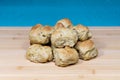 Fresh baked biscuits stacked on a wooden butcher block