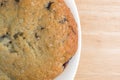 Fresh baked blueberry muffin top on a white plate Royalty Free Stock Photo