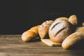 Fresh baked bread with a golden crust, loaf, buns, white, rye on a rustic wooden background . Horizontal frame Royalty Free Stock Photo