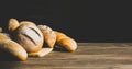 Fresh baked bread with a golden crust, loaf, buns, white, rye on a rustic wooden background . Horizontal frame Royalty Free Stock Photo