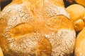 Fresh baked bread with a golden crust, loaf, buns, white, rye on a rustic wooden background with sil rustic. Flat layout