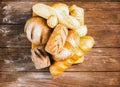 Fresh baked bread with a golden crust, loaf, buns, white, rye on a rustic wooden background with sil rustic. Flat layout