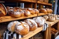 fresh baked bread loaves on wooden shelf at farmers market Royalty Free Stock Photo