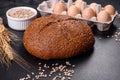 Fresh baked brown bread with ears and grains of wheat Royalty Free Stock Photo