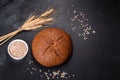 Fresh baked brown bread with ears and grains of wheat Royalty Free Stock Photo