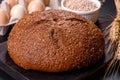 Fresh baked brown bread with ears and grains of wheat Royalty Free Stock Photo