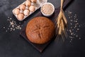 Fresh baked brown bread with ears and grains of wheat Royalty Free Stock Photo