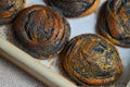 Fresh baked buns with poppy seeds on a tray on wooden background