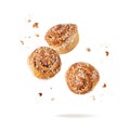 Fresh baked cinnamon buns with crumbs flying falling isolated on white background Royalty Free Stock Photo