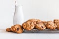 Fresh baked cookies on a cooling rack near an old fashioned milk bottle