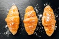 Fresh baked croissant sprinkled with powdered sugar