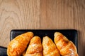 Fresh baked croissant sprinkled with powdered sugar