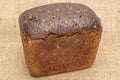 Fresh baked dark bread on jute