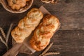 Fresh baked goods - delicious wicker buns on a wooden background with copy space