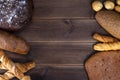 Fresh baked goods food, rustic crisp bread loaves and muffins on a wooden table. Top view and copy space for text Royalty Free Stock Photo