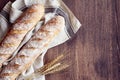 Fresh baked homemade crusty bread baguette. Two loaves on linen towel