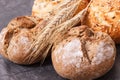 Fresh baked homemade wholegrain rolls or bread with seeds and ears of grain Royalty Free Stock Photo