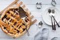 A fresh baked lattice cherry pie with pie server and plates, ready for serving. Royalty Free Stock Photo