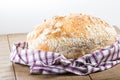 Fresh baked loaf of bread in cloth Royalty Free Stock Photo