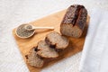 Fresh baked loaf of spelt sourdough bread with hemp seeds is on linen towel. Healthy pastry