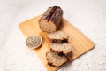 Fresh baked loaf of spelt sourdough bread with hemp seeds is on linen towel. Healthy pastry