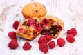 Fresh baked muffins with chocolate and raspberries on wooden background, delicious dessert Royalty Free Stock Photo