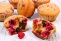 Fresh baked muffins with chocolate and raspberries on wooden background, delicious dessert Royalty Free Stock Photo