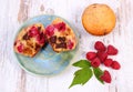 Fresh baked muffins with chocolate and raspberries on wooden background, delicious dessert Royalty Free Stock Photo