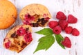 Fresh baked muffins with chocolate and raspberries on wooden background, delicious dessert Royalty Free Stock Photo