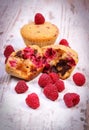 Fresh baked muffins with chocolate and raspberries on wooden background, delicious dessert Royalty Free Stock Photo