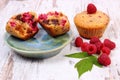 Fresh baked muffins with chocolate and raspberries on wooden background, delicious dessert Royalty Free Stock Photo