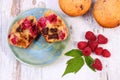 Fresh baked muffins with chocolate and raspberries on wooden background, delicious dessert Royalty Free Stock Photo