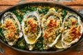 Fresh Baked Oysters with Spinach and Bread Crumbs on Rustic Wooden Table, Delicious Seafood Dish Concept Royalty Free Stock Photo