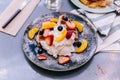 Fresh baked Pancakes topping with strawberry, orange, blueberry and whip cream Royalty Free Stock Photo