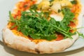 Fresh baked pizza with melted cheese, Italian herbs and tomato sauce and fresh basil on a white plate. Italian food, menu, restaur