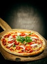 Fresh Baked Pizza Served on Wooden Pizza Paddle Royalty Free Stock Photo