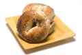 Fresh baked poppy seed bagels on plate Royalty Free Stock Photo