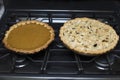 Fresh Baked Pumpkin and Apple Pie on Oven in Kitchen Royalty Free Stock Photo