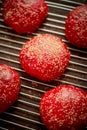 Fresh baked red homemade burger buns with sesame top view. Placed on metal grill. Royalty Free Stock Photo