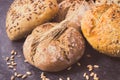 Fresh baked rolls with seeds and ears of rye or wheat grain. Vintage photo Royalty Free Stock Photo