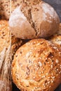 Fresh baked rolls with seeds and ears of rye or wheat grain Royalty Free Stock Photo