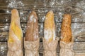 Fresh baked rustic bread loaves in paper bags on dark wood background Royalty Free Stock Photo