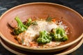 Fresh baked sea fish with broccoli, carrots, vegetables and cheese