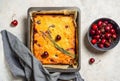 Fresh baked sweet cherry pie or red brownie cake in baking sheet with lavender, napkin and raw berries aside. Royalty Free Stock Photo