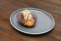 fresh baked sweet creamy eclair sweet dessert on plate kitchen wooden table, sugar food, utensils dishware, home cooking