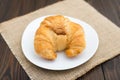 Fresh baked tasty croissants on brown napkin