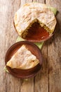 Fresh baked traditional Moroccan Pastilla or chicken bastilla closeup in the plate. Vertical top view