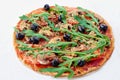 Fresh baked vegetarian pizza with mushrooms, tomatoes, rucola, black olives isolated on the white table Royalty Free Stock Photo