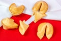 Fresh baked yellow Chinese fortune cookies with white blank note inside on red background. Royalty Free Stock Photo